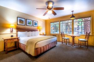a hotel room with a bed and a table and chairs at Yosemite Valley Lodge in Yosemite Village