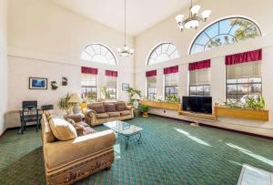 a large living room with couches and a flat screen tv at Rodeway Inn Decatur in Decatur