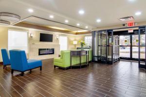 a living room with a couch and chairs and a fireplace at Comfort Inn Acworth - Kennesaw Northwest in Acworth