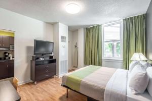 a hotel room with a bed and a television at Quality Inn & Suites Kansas City Downtown in Kansas City