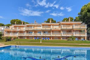 a large building with a large swimming pool in front of it at Poolbeach V in Moraira