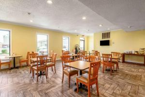 a dining room with wooden tables and chairs at Quality Inn New Orleans I-10 East in New Orleans