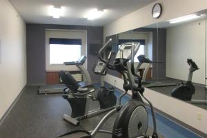 a gym with two tread machines and a mirror at Quality Inn & Suites in Caldwell