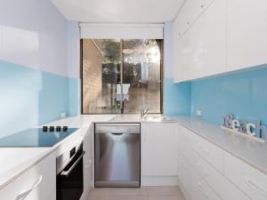 a kitchen with a sink and a dishwasher at Harbourside 4 ground floor on the waterfront in Soldiers Point