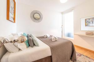 a bedroom with a bed and a lamp and a window at GuestReady - Porta de Alfama for up to 6 guests! in Lisbon