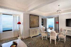 a living room with a table and chairs at The Ambassador, Marine Drive, Mumbai in Mumbai