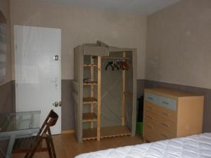a bedroom with a bed and a dresser and a closet at L'auberge des travailleurs in Échirolles