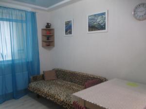 a living room with a couch and a table at проспект Правды 41-е in Kyiv