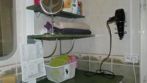 a bathroom with a shelf with towels and a phone at appartement 3 chambres, idéal pour déplacement in Échirolles