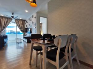 a dining room table and chairs in a living room at Thermospace The Wave B-13A-13 Melaka City in Melaka
