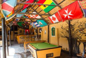 a room with a pool table and a flag at Lusaka Backpackers in Lusaka