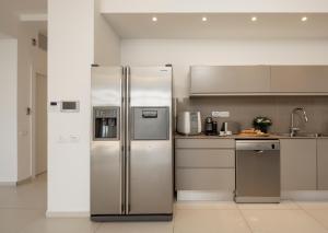 a kitchen with a stainless steel refrigerator at Beach House Galei in Herzliyya B