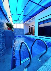 una piscina con iluminación azul en una casa en VILLA MB en Bogor