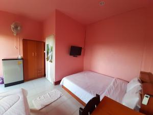 a bedroom with a white bed and a red wall at Khuang Na Farmview in Ban Tambon Bang Khae +27 photos