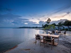 a group of tables and chairs on the beach at Rocky's Boutique Resort - Veranda Collection Samui in Lamai
