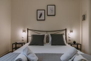 a bedroom with a large bed with two night stands at HB Modern Apartments in Tolo