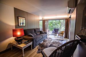 a living room with a couch and a table at Quinta dos Carqueijais Gerês in Geres