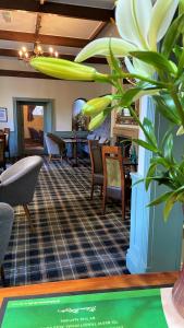 a lobby with chairs and a table and a plant at Hickman Hill Hotel in Gainsborough