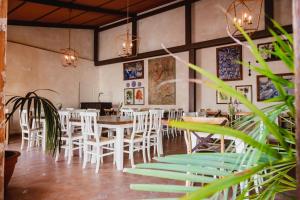 a dining room with white chairs and tables at Puerta de Algadir in El Puerto de Santa María