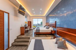 a bedroom with two beds and a blue wall at Casa Dos Lunas in Oaxaca City