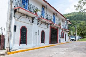 un bâtiment avec des portes rouges et bleues dans une rue dans l'établissement Hotel Isis, à Zihuatanejo