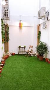 a patio with green grass and a table at Alexis KT Roomstay in Kuala Terengganu