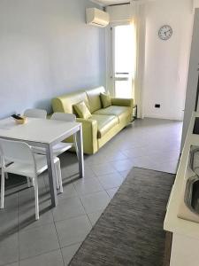 a living room with a couch and a table at Panoramic Center Bovisa in Milan