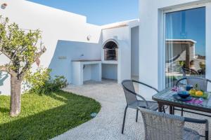 eine Terrasse mit Tisch und Stühlen in einem Hof in der Unterkunft Casa Victoria in Vejer de la Frontera