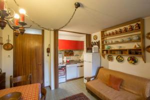 a living room with a couch and a kitchen at ALTIDO Apt for 7 with Terrace and Exceptional Location in Courmayeur