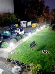 a park with cars parked in a parking lot with lights at Villa Iris in Kołobrzeg