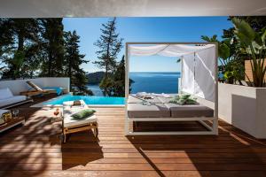 a bedroom with a bed and a swimming pool at Villa T Dubrovnik - Wellness and Spa Luxury Villa with spectacular Old Town view in Dubrovnik
