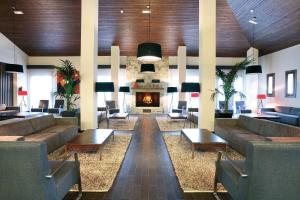 a lobby with couches and a fire place at Hotel & Spa Real Badaguás Jaca in Badaguás