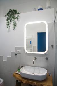 a bathroom with a sink and a mirror at Riflessi DaMare Room & Apartment in Salerno