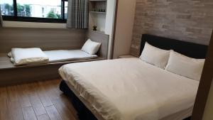 En eller flere senger på et rom på 渡小夜電梯民宿 Yilannight B&B