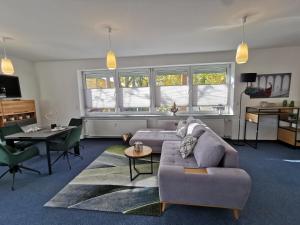 a living room with a couch and a table at Bahnhof City Loft & Apartments in Augsburg