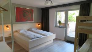 Un dormitorio pequeño con una cama y una ventana. en Braunhof Apartments, en Hainzenberg