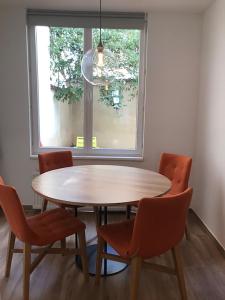 a table and chairs in a room with a window at Brussel House Basilic in Brussels