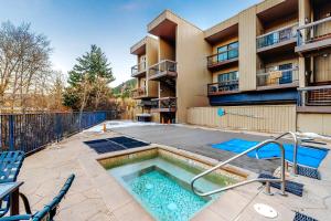 a swimming pool in front of a apartment building at SunRiver Mountain Getaway in Avon