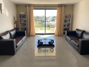 a living room with two couches and a coffee table at Buganvília Holidays in Alvor