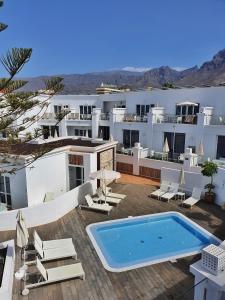 a resort with a swimming pool and white buildings at Flamingo Beach Mate in Adeje