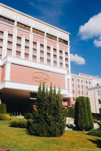 
a large building with a clock on the front of it at President Hotel in Minsk
