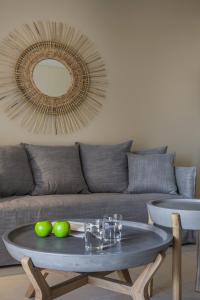 a living room with a table and a couch with a mirror at Deluxe Kefalonia Apartment Apartment Helios 1 Bedroom Outdoor Pool Karavomilos in Karavomylos