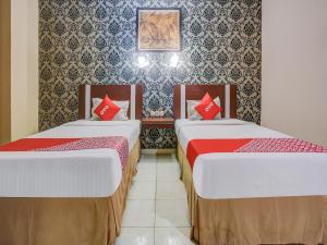 Super OYO 3936 Hotel Trisula Makassar 객실 침대