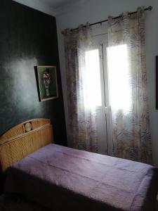 A bed or beds in a room at Alcaravaneras Hostel