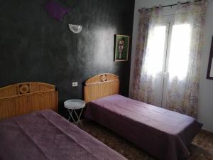 A bed or beds in a room at Alcaravaneras Hostel