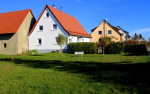 a white house with an orange roof in a yard at Marienhof in Leibertingen