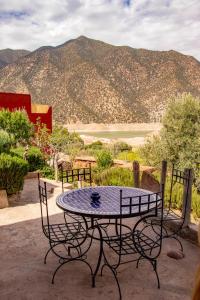 a table and chairs with a view of a mountain at Riad Diwane in Ouirgane