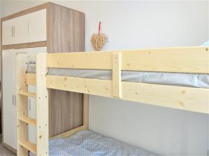 a wooden bunk bed in a room at Modern apartment in Lviv