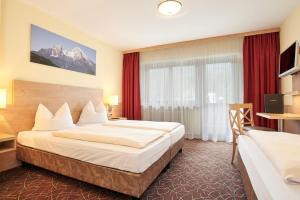 Postel nebo postele na pokoji v ubytování Alpen-Hotel Seimler