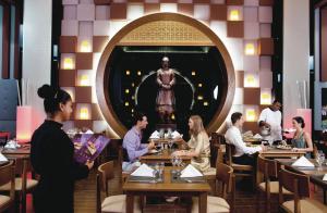 a group of people sitting at tables in a restaurant at Riu Playa Blanca - All Inclusive in Playa Blanca